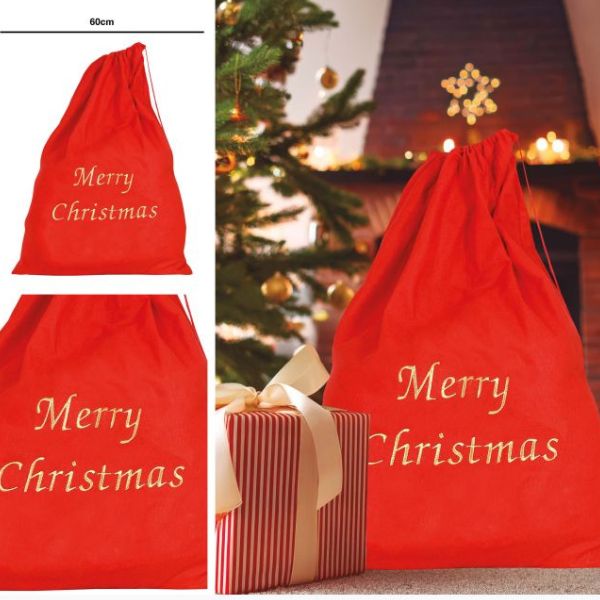 grand sac de Noël rouge Merry Christmas devant un sapin